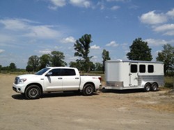 A truck towing a horse trailer.